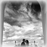 kiss under arch, in black and white
